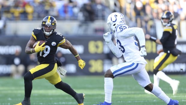 Pittsburgh Steelers wide receiver JuJu Smith-Schuster (19) tries to elude Indianapolis Colts linebacker Darius Leonard (53) in a 2019 game at Pittsburgh's Heinz Field.